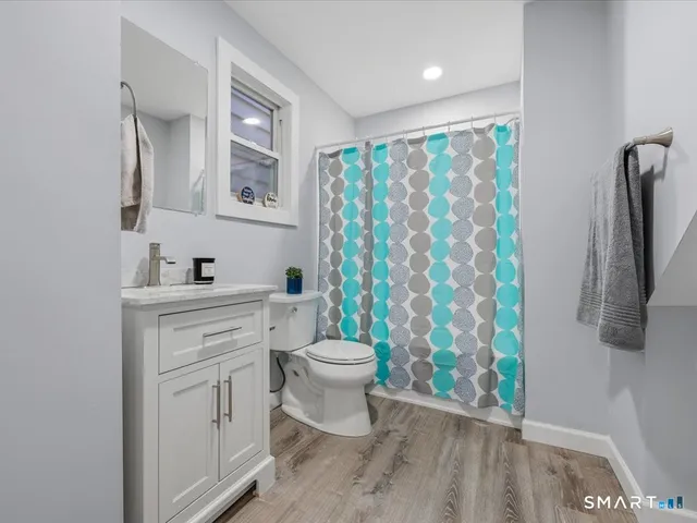 a bathroom with a sink toilet and shower