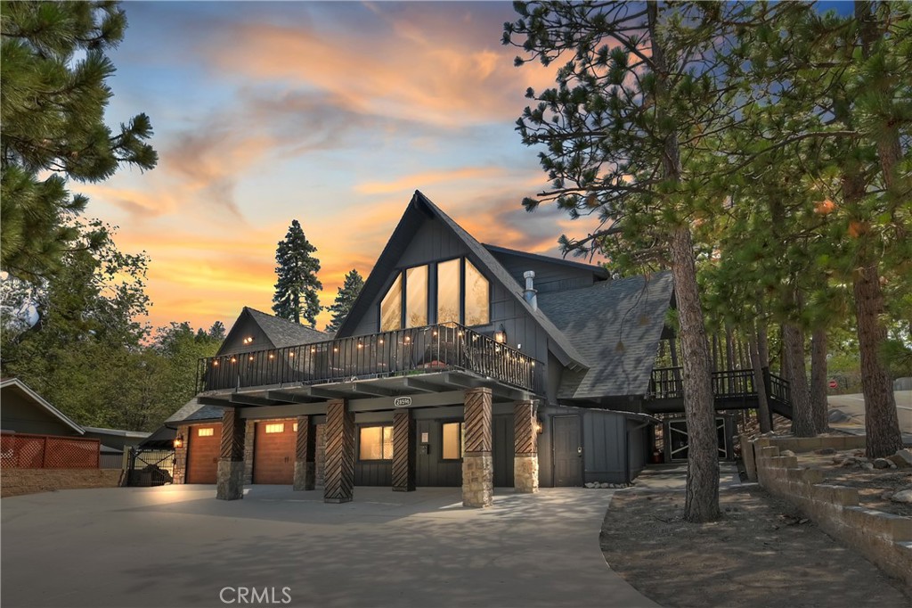 a front view of a house with a tree