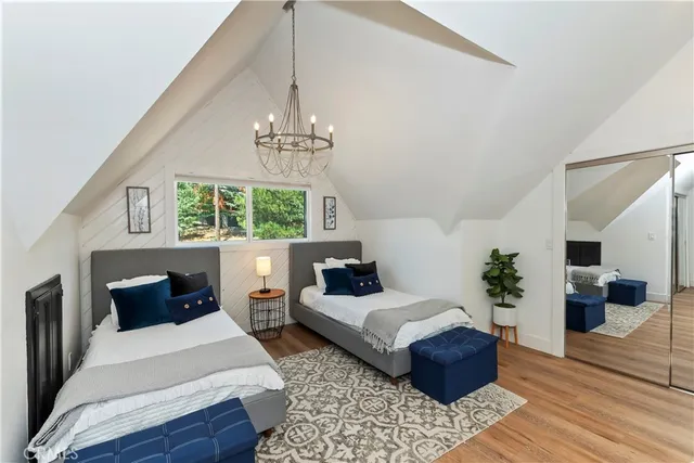 a bedroom with a large bed and a chandelier