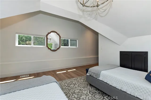 a bedroom with a bed and a mirror