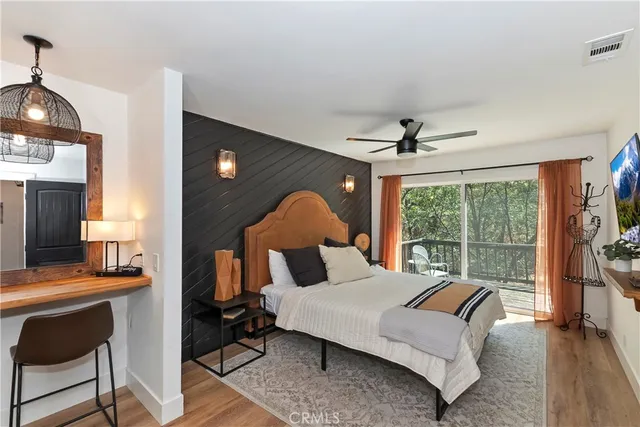 a bed room with a bed and a ceiling fan