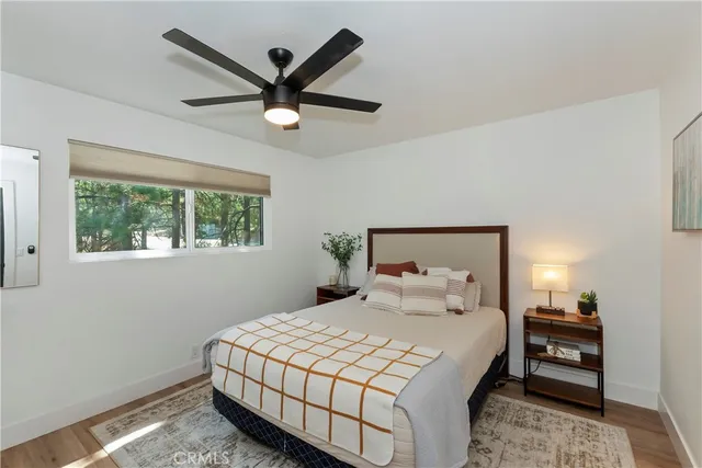 a bedroom with a bed and a large window