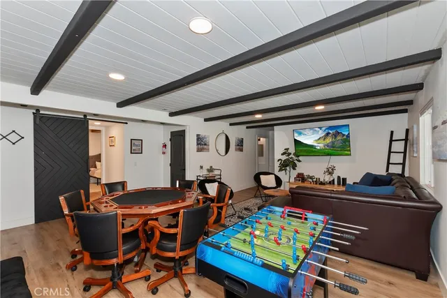 a kitchen with stainless steel appliances granite countertop a stove a sink dishwasher and white cabinets with wooden floor