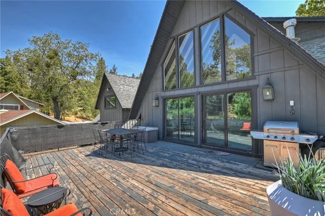 a view of a chairs and table on the wooden deck
