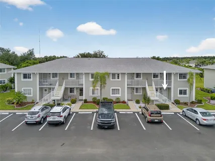 a view of a patio with table and chairs under an umbrella