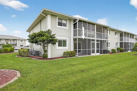 a view of a house with backyard and garden