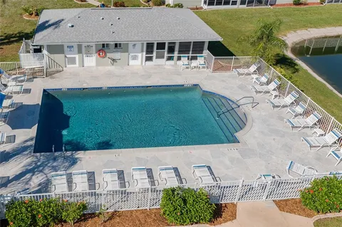 an aerial view of a house with swimming pool garden and patio