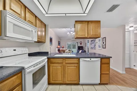 a kitchen with stainless steel appliances granite countertop a stove and a sink