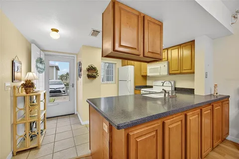 a kitchen with stainless steel appliances granite countertop a sink and cabinets