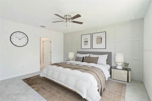 a bedroom with a large bed and a chandelier