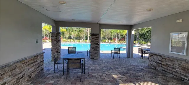 a view of a dining room with furniture large windows and wooden floor