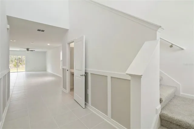a view of a hallway with a couch and a window