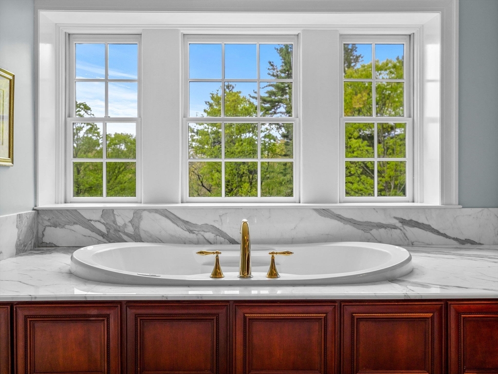 90 Burr Drive Needham, MA 02492 - Photo 27 of 41 a bathroom with a granite countertop sink and bathtub