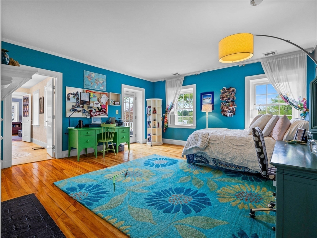 90 Burr Drive Needham, MA 02492 - Photo 28 of 41 a bedroom with a bed and flat screen tv