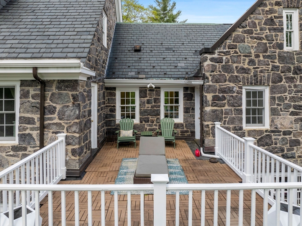 90 Burr Drive Needham, MA 02492 - Photo 29 of 41 a stairs and a table in the balcony