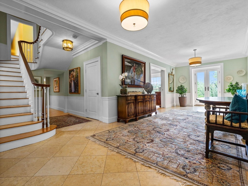 90 Burr Drive Needham, MA 02492 - Photo 4 of 41 a view of a livingroom with furniture and staircase