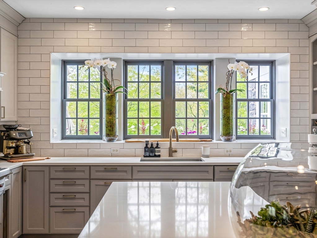 90 Burr Drive Needham, MA 02492 - Photo 7 of 41 a kitchen with stainless steel appliances a sink a stove and a window