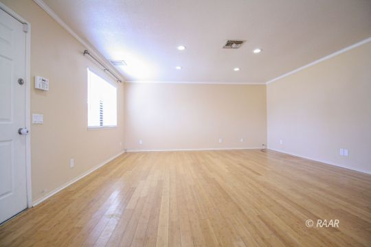 408 South Valley Street Ridgecrest, CA 93555 - Photo 4 of 29 wooden floor in an empty room with a window