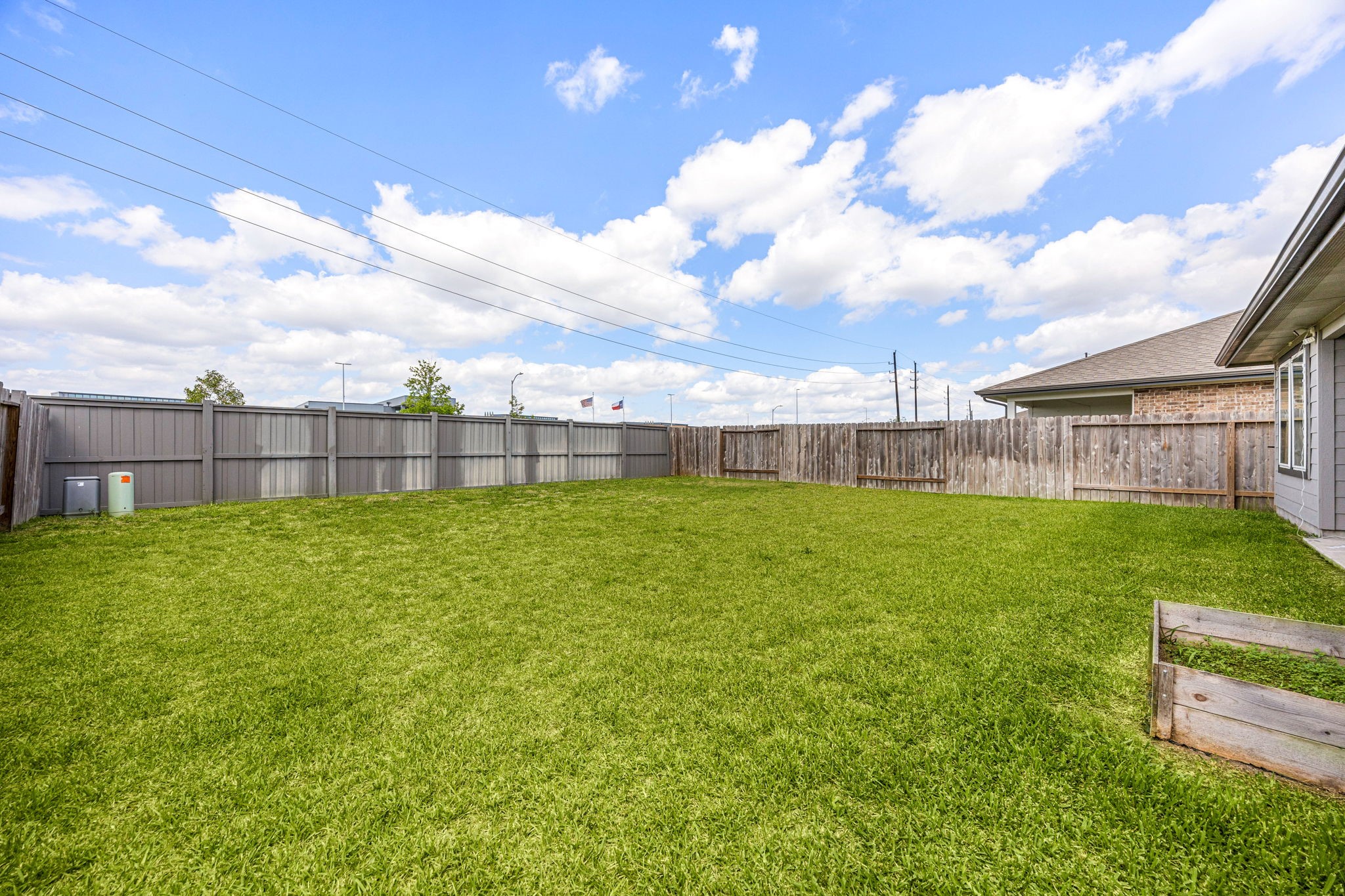 711 Alpine Fls Road Rosharon, TX 77583 - Photo 16 of 20 The covered back patio provides a shaded retreat perfect for al fresco dining or enjoying a quiet evening in the fresh air. Whether you're hosting a summer barbecue or relaxing in the peace of your own lawn, this outdoor space serves as a serene and private extension of the home's modern living area.
