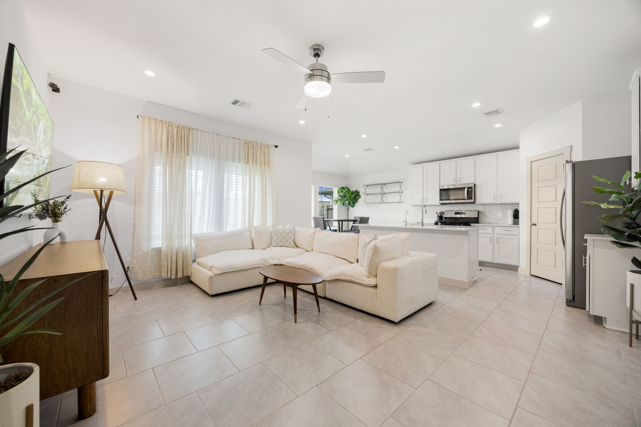 711 Alpine Fls Road Rosharon, TX 77583 - Photo 19 of 20 This bright, airy open-concept floor plan is designed for modern living and effortless entertaining. Large windows bathe the spacious family room in natural light, beautifully highlighting the sleek, neutral tile flooring that flows throughout.