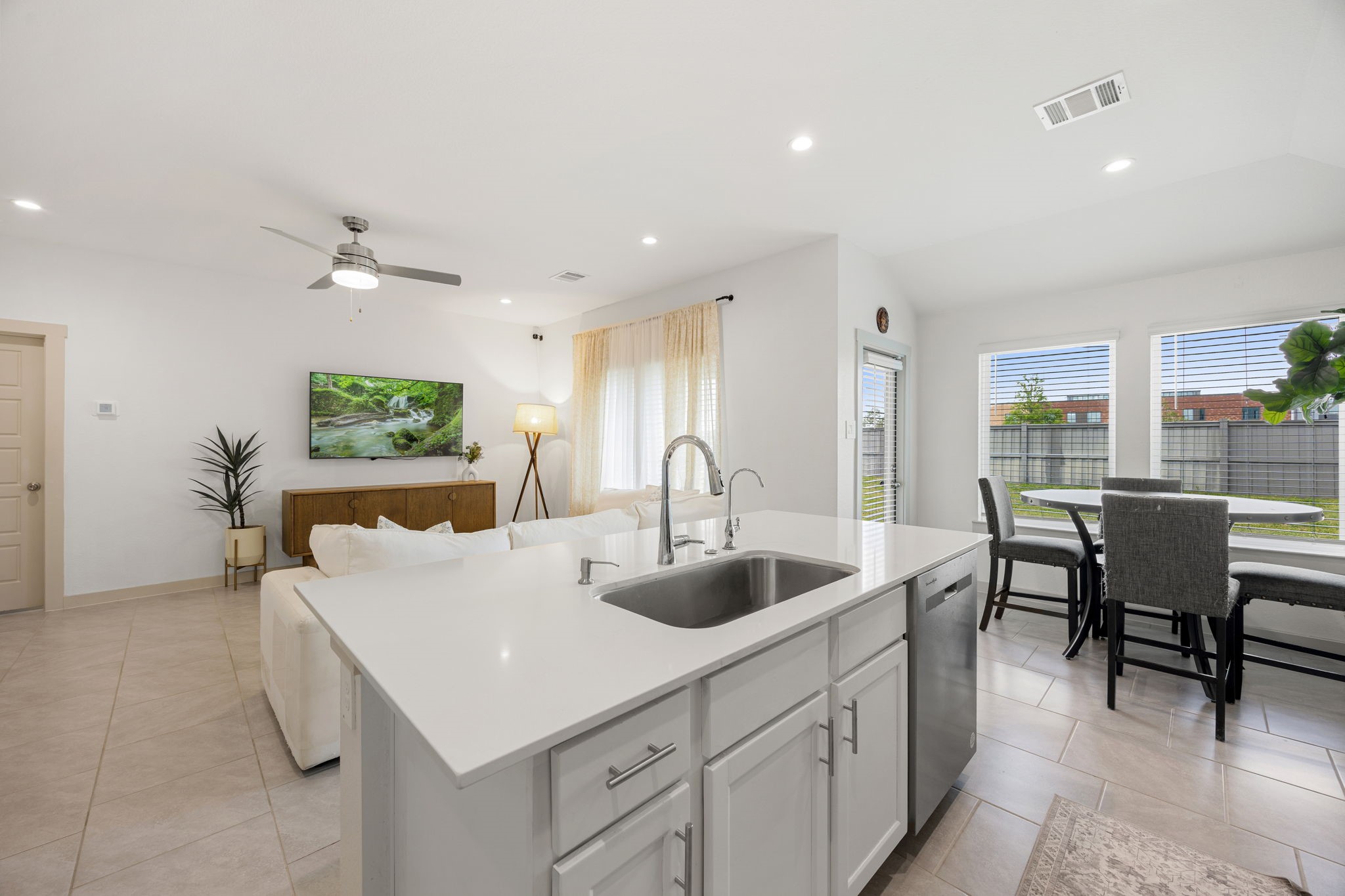 711 Alpine Fls Road Rosharon, TX 77583 - Photo 7 of 20 The massive oversized island doubles as a convenient breakfast bar, complete with a modern undermount sink and designer faucet. Overlooking the bright, airy family room, this chef-inspired space is illuminated by elegant recessed lighting, making it as functional as it is beautiful for both daily living and high-end entertaining.
