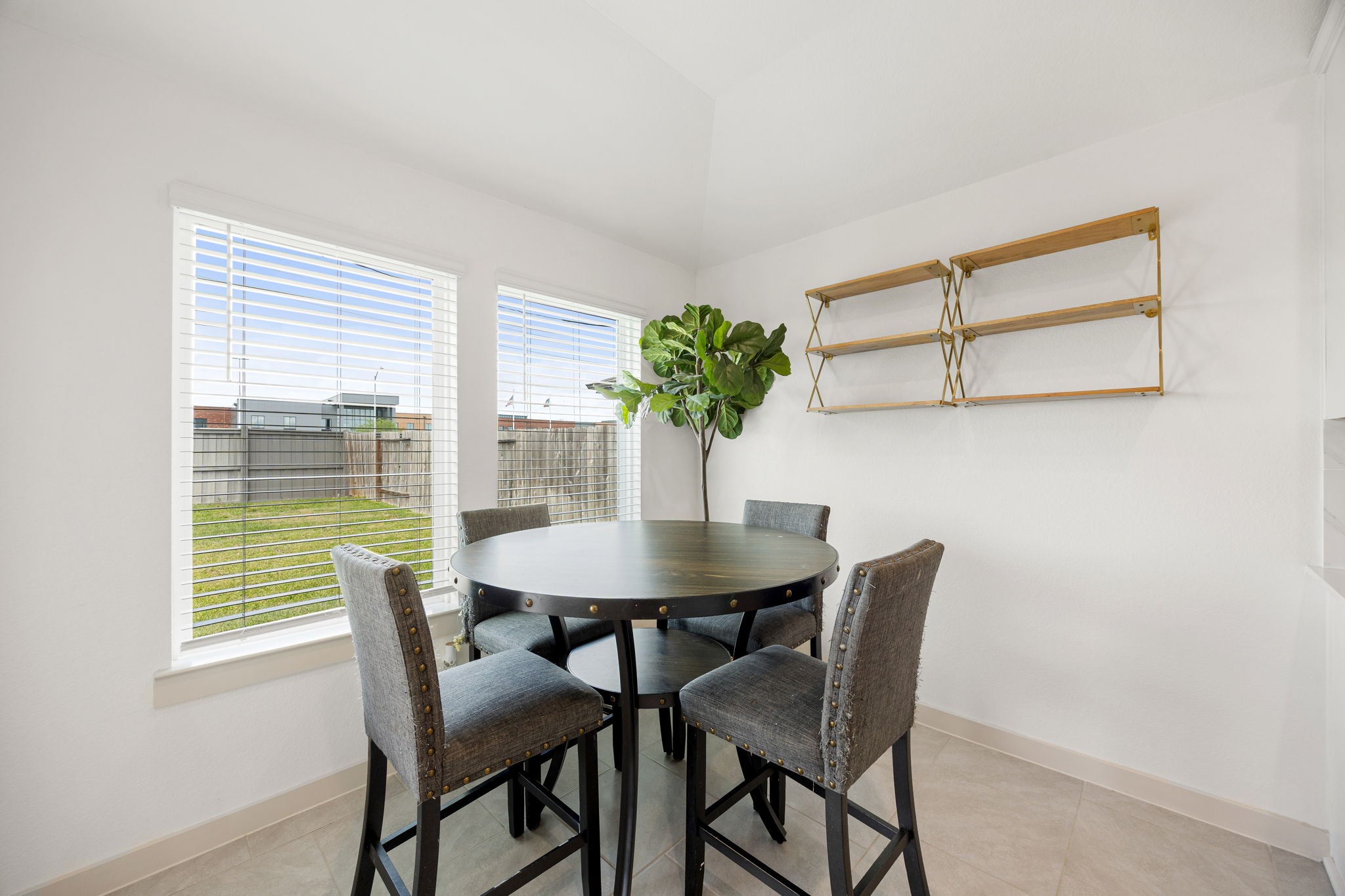 711 Alpine Fls Road Rosharon, TX 77583 - Photo 8 of 20 This charming sun-drenched breakfast/dining offers the perfect setting for morning coffee or casual family meals. Large picture windows frame refreshing views of the lush green backyard, inviting an abundance of natural light to fill the space.