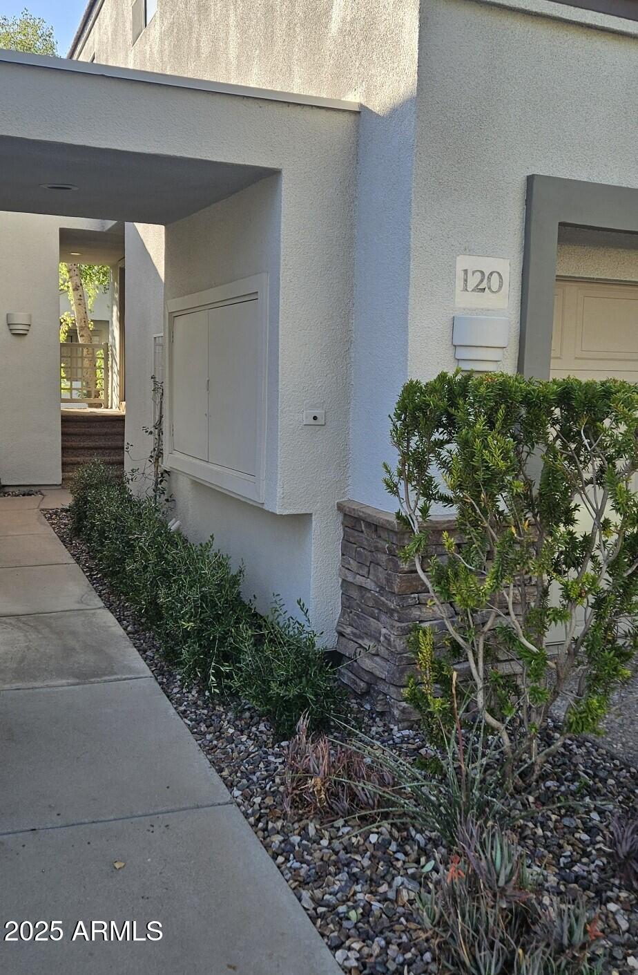 7272 East Gainey Ranch Road, Unit 120 Scottsdale, AZ 85258 - Photo 17 of 26 a front view of a house with garden