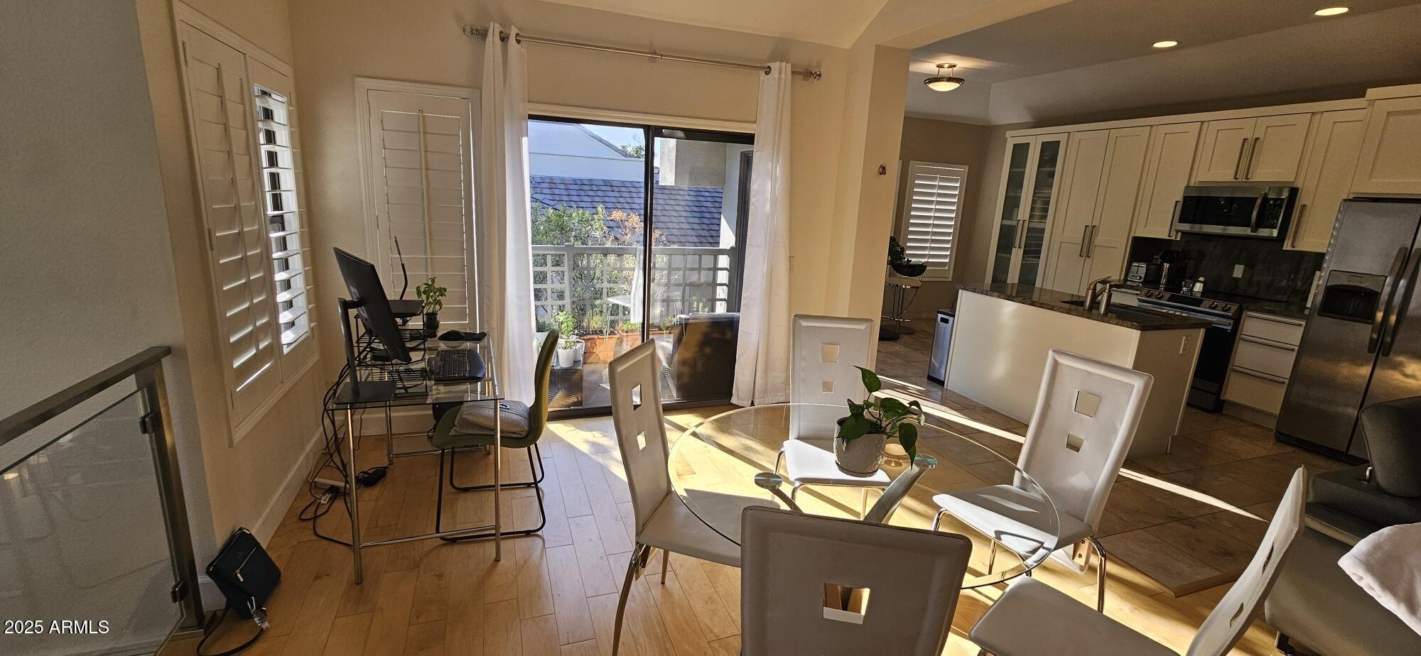 7272 East Gainey Ranch Road, Unit 120 Scottsdale, AZ 85258 - Photo 2 of 26 a view of a dining room with furniture window and wooden floor