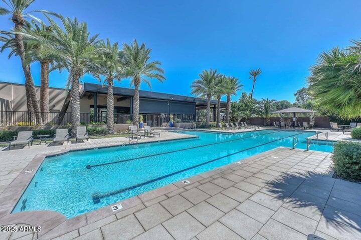7272 East Gainey Ranch Road, Unit 120 Scottsdale, AZ 85258 - Photo 25 of 26 a swimming pool with outdoor seating and yard