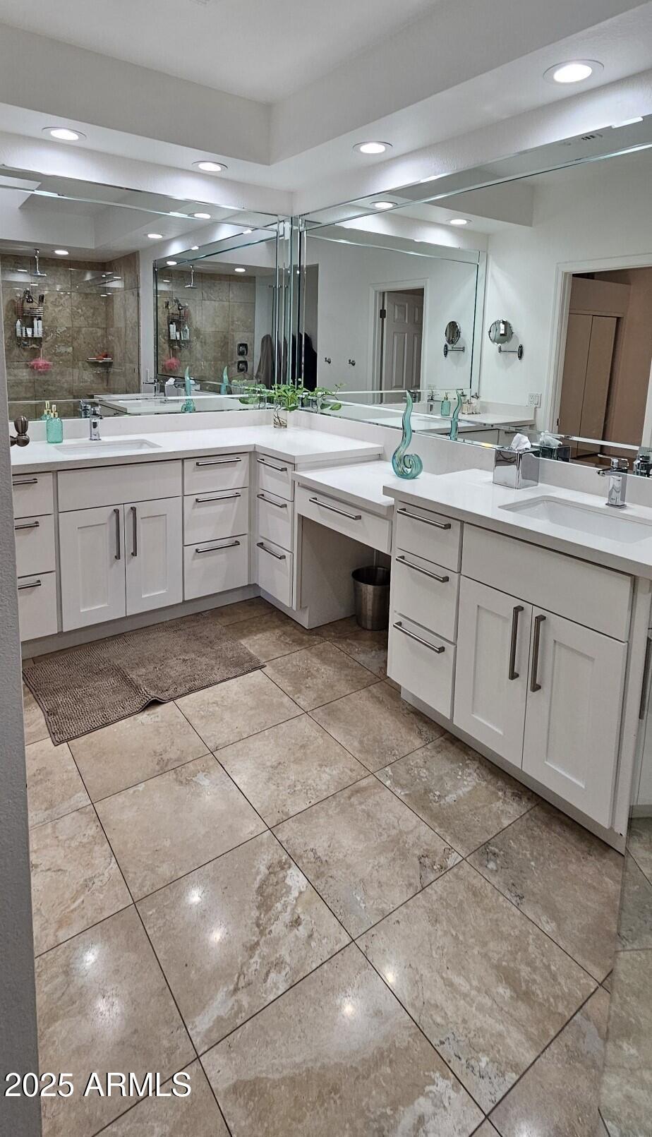 7272 East Gainey Ranch Road, Unit 120 Scottsdale, AZ 85258 - Photo 9 of 26 a large white kitchen with a sink and cabinets
