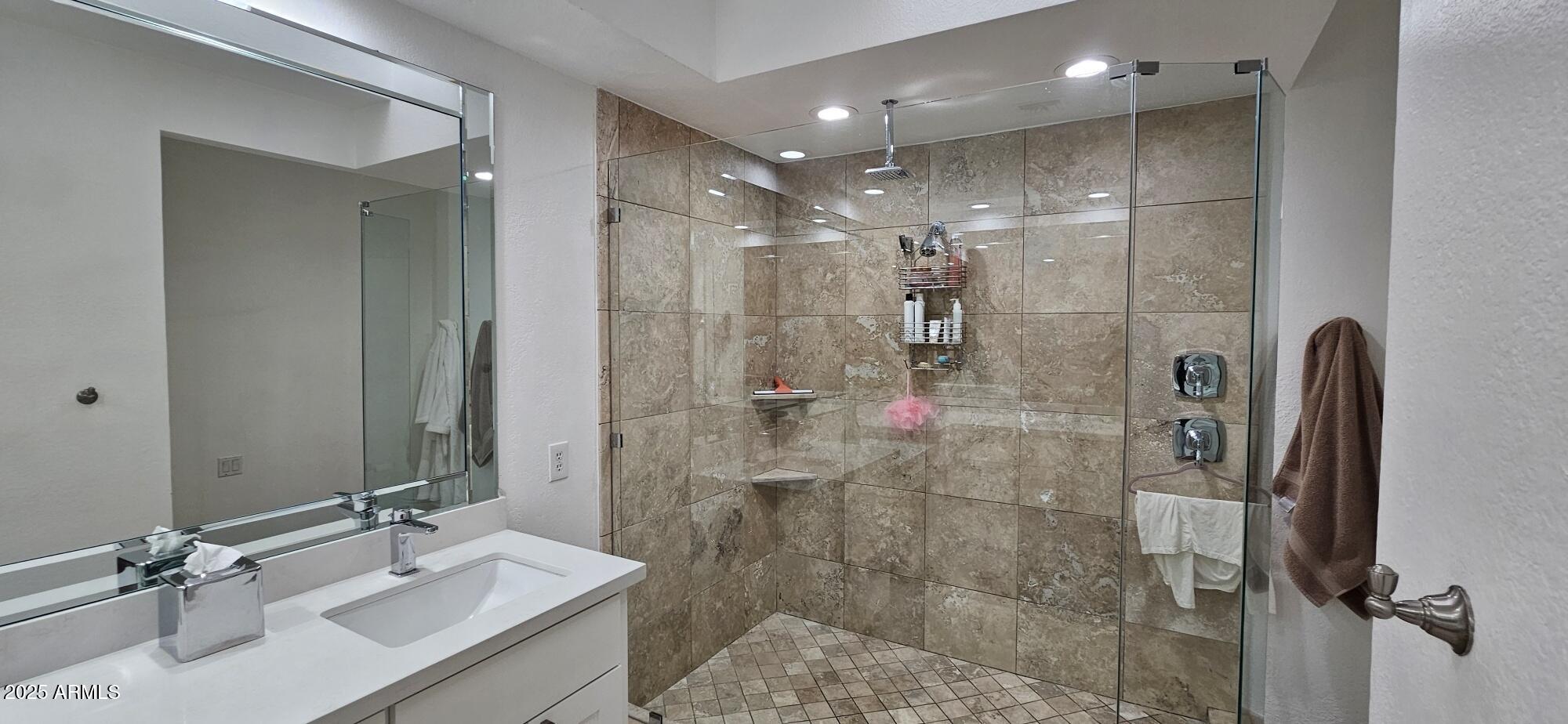 7272 East Gainey Ranch Road, Unit 120 Scottsdale, AZ 85258 - Photo 10 of 26 a bathroom with a shower sink and mirror