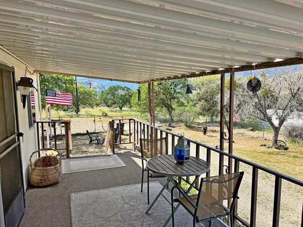 a view of a chairs and table in patio