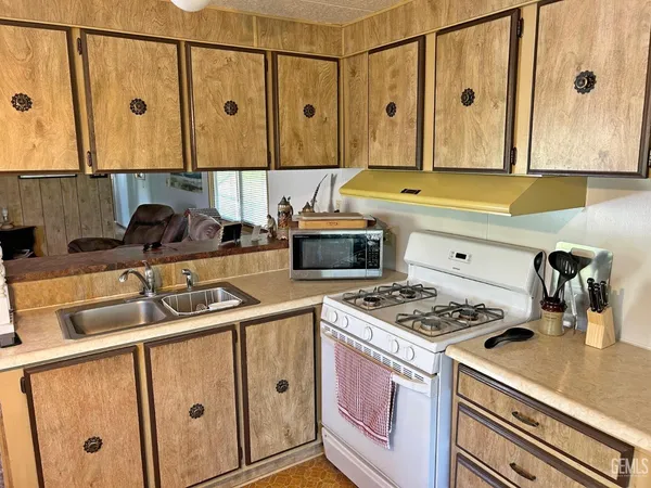 a kitchen with stainless steel appliances granite countertop a stove and a sink