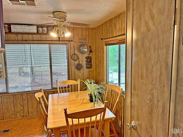 a view of a dining room with furniture and chandelier