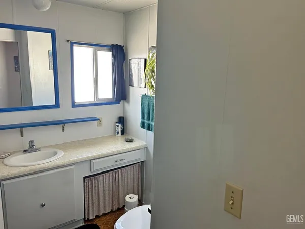 a bathroom with a sink toilet and mirror