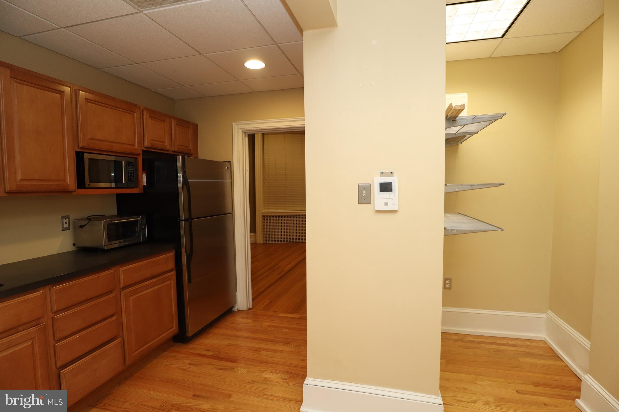 1608 Spruce Street, Unit 2 Philadelphia, PA 19103 - Photo 12 of 19 a kitchen with a refrigerator and cabinets
