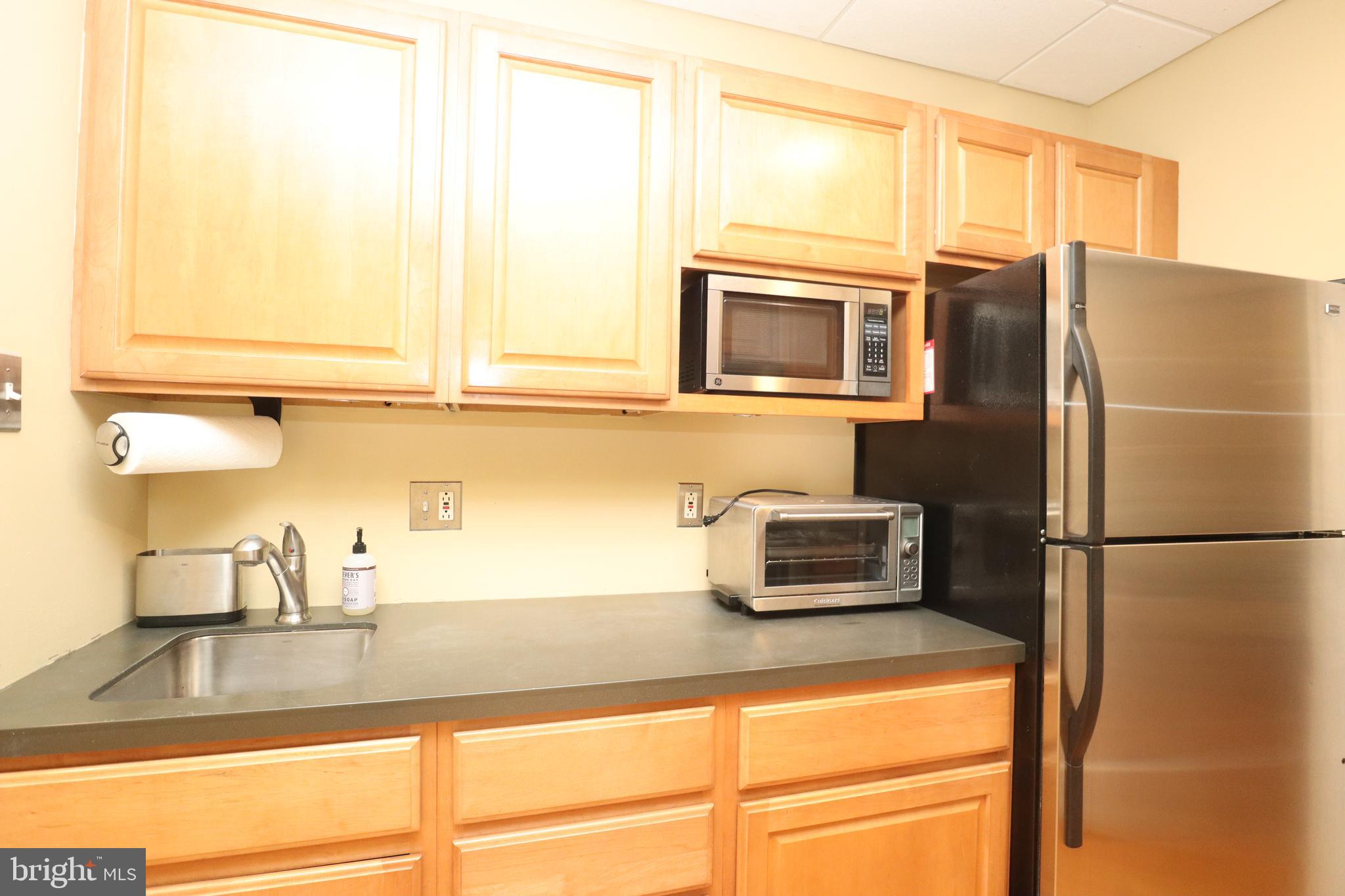 1608 Spruce Street, Unit 2 Philadelphia, PA 19103 - Photo 13 of 19 a kitchen with granite countertop a refrigerator and a sink