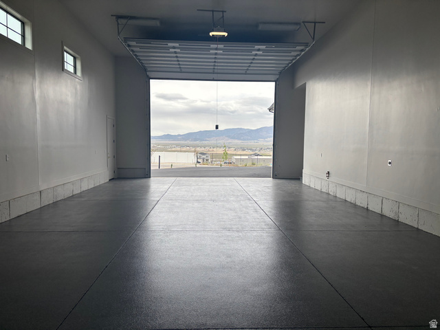 2828 Jojo Road Eagle Mountain, UT 84005 - Photo 51 of 63 Spacious garage with an epoxy-coated concrete floor, white painted walls, and overhead lighting