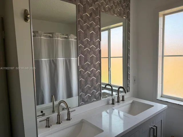 a bathroom with a sink and a large mirror