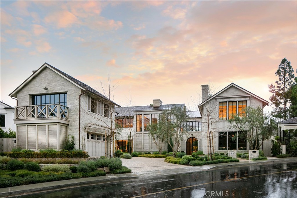 a view of a big house in a big yard with large trees