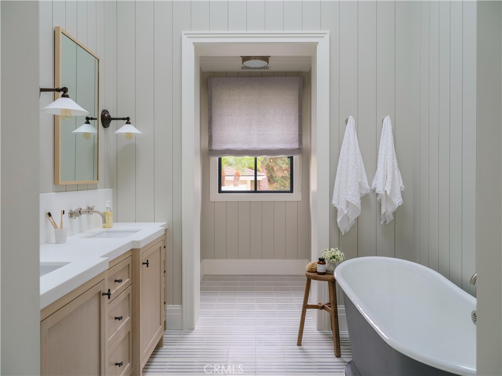 12 Burning Tree Road Newport Beach, CA 92660 - Photo 19 of 32 a bathroom with a tub sink and mirror