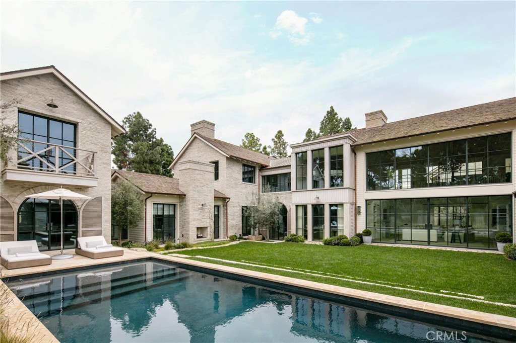 12 Burning Tree Road Newport Beach, CA 92660 - Photo 31 of 32 a front view of a house with a yard table and chairs