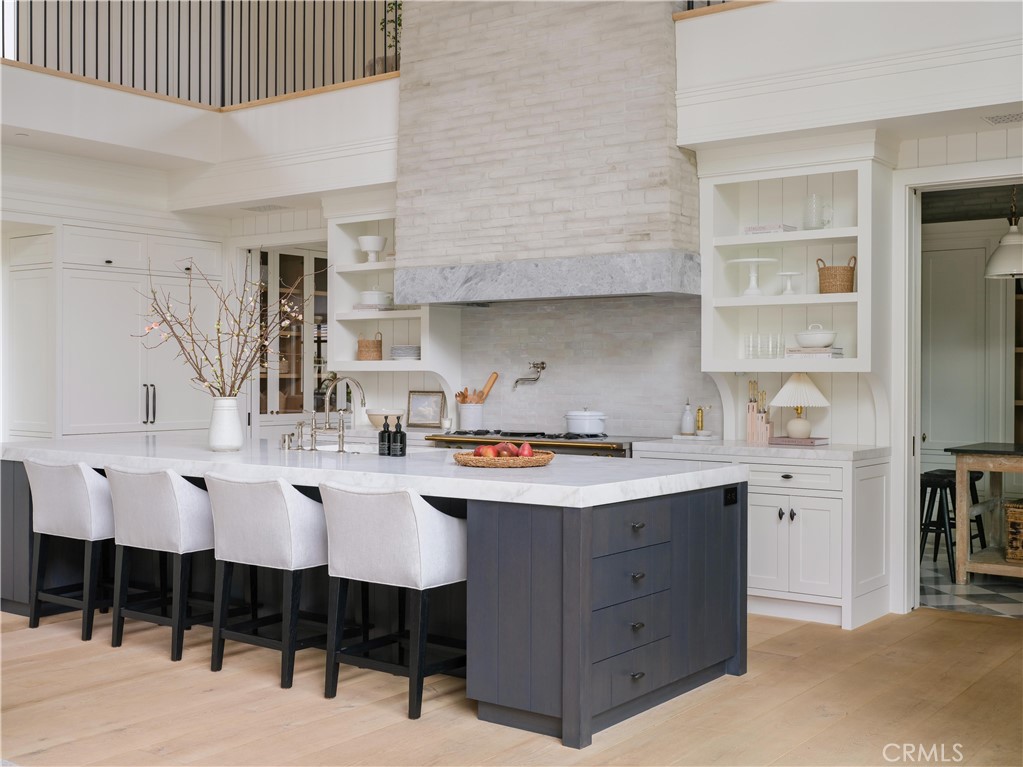 12 Burning Tree Road Newport Beach, CA 92660 - Photo 5 of 32 a kitchen with a sink and chairs