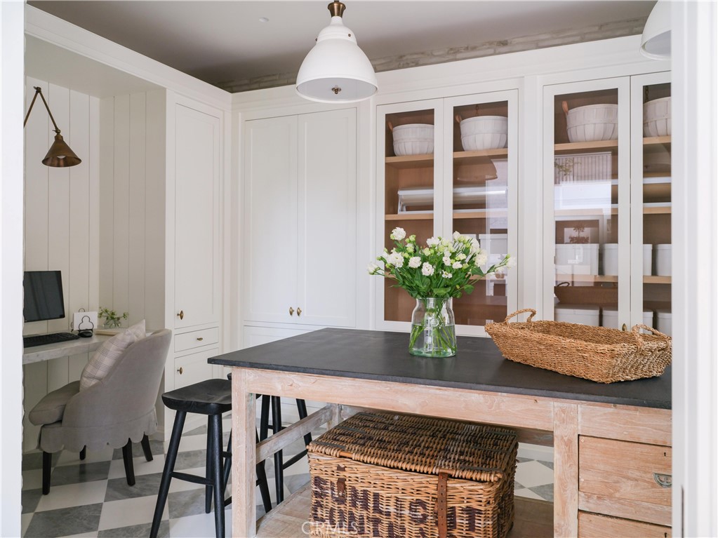 12 Burning Tree Road Newport Beach, CA 92660 - Photo 9 of 32 a table that has a table and a chair with wooden floor