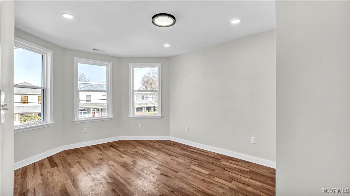 1320 Decatur Street Richmond, VA 23224 - Photo 15 of 36 an empty room with wooden floor and windows