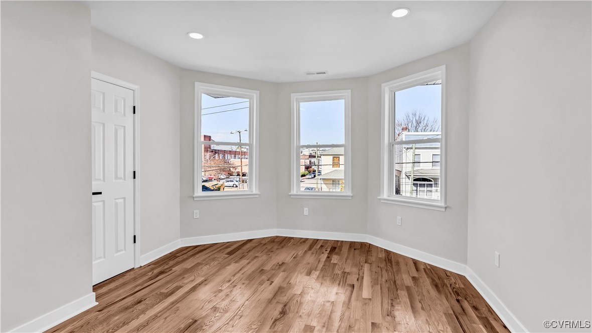 1320 Decatur Street Richmond, VA 23224 - Photo 16 of 36 an empty room with wooden floor and windows