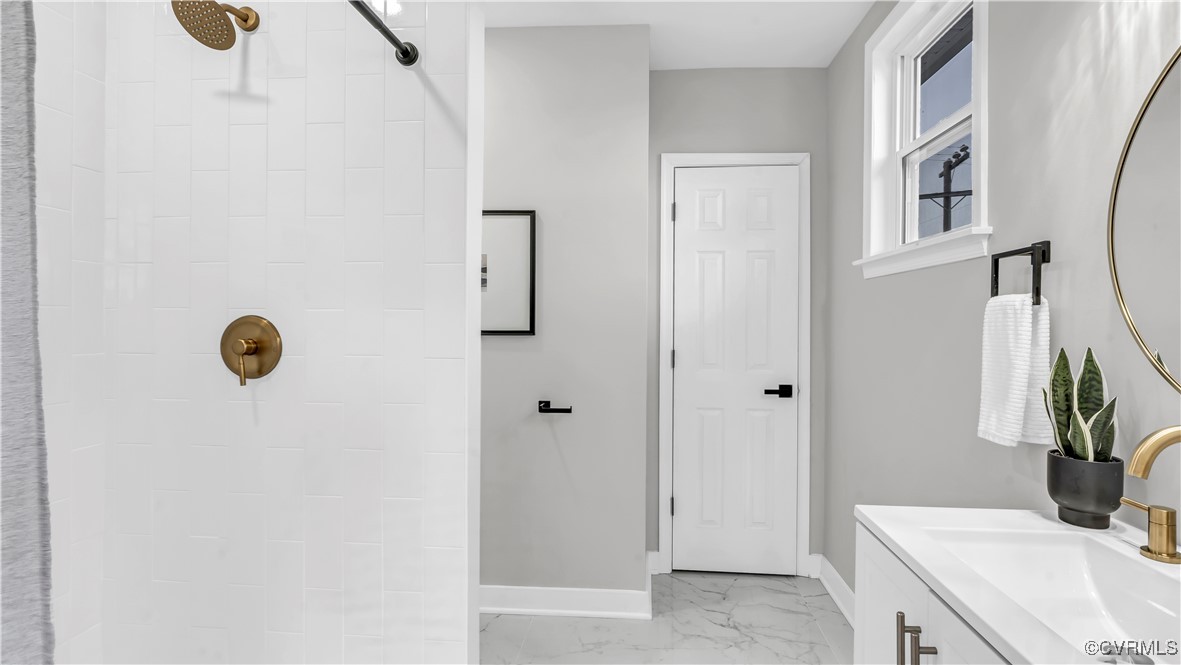 1320 Decatur Street Richmond, VA 23224 - Photo 19 of 36 a bathroom with a sink a mirror and shower