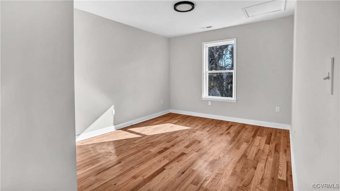 1320 Decatur Street Richmond, VA 23224 - Photo 24 of 36 an empty room with wooden floor and windows