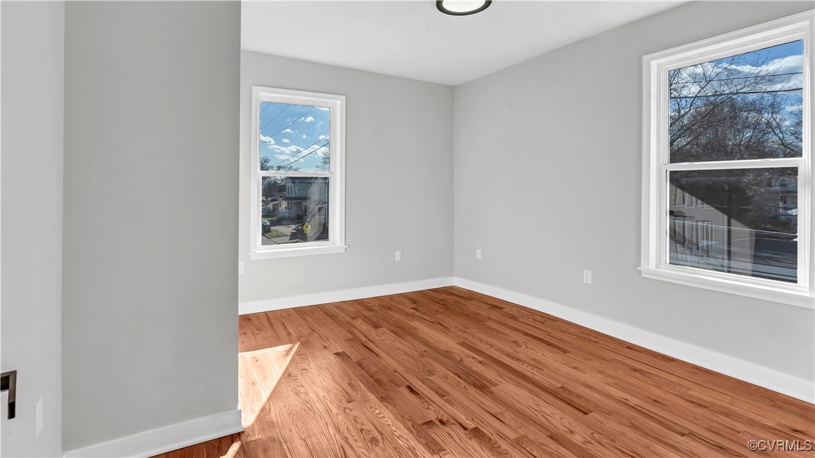 1320 Decatur Street Richmond, VA 23224 - Photo 26 of 36 a view of an empty room with wooden floor and a window
