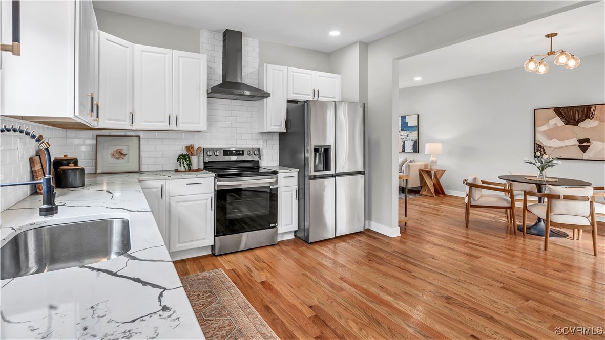 1320 Decatur Street Richmond, VA 23224 - Photo 6 of 36 a kitchen with stainless steel appliances granite countertop a stove a sink dishwasher and a refrigerator with wooden floor